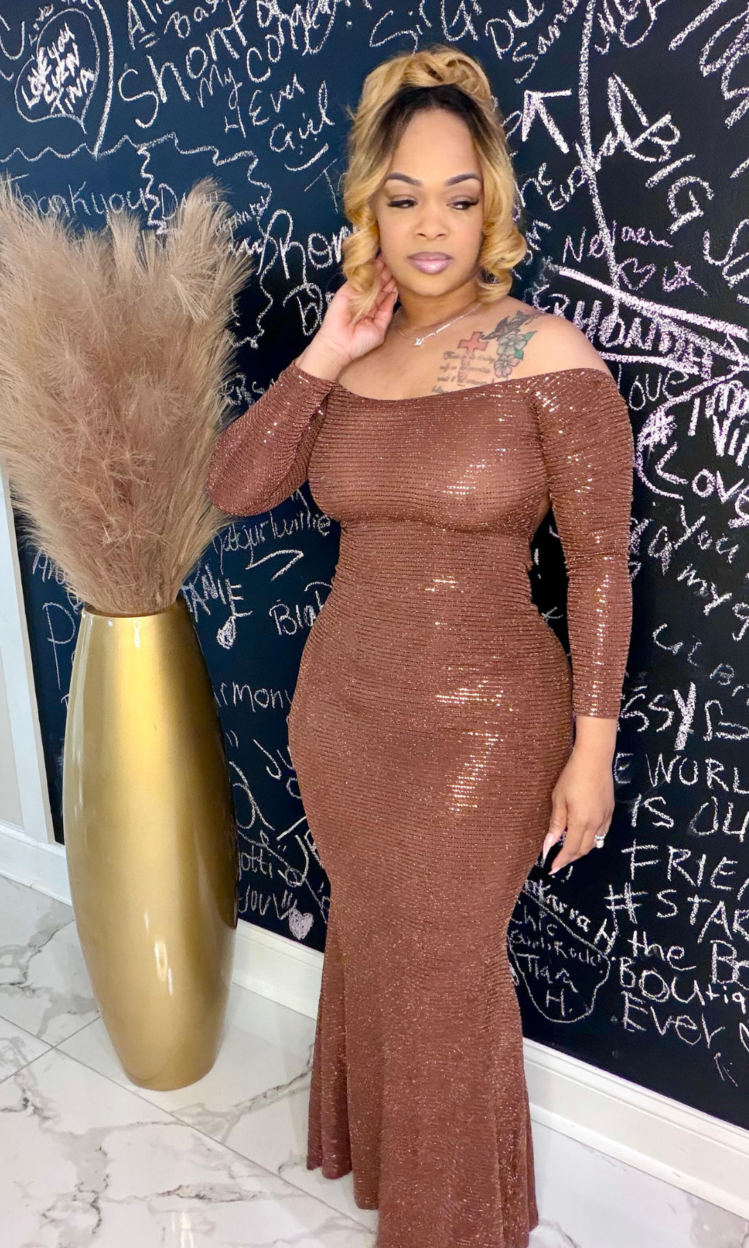 Model wearing Queen Susie bronze off-the-shoulder gown, front view