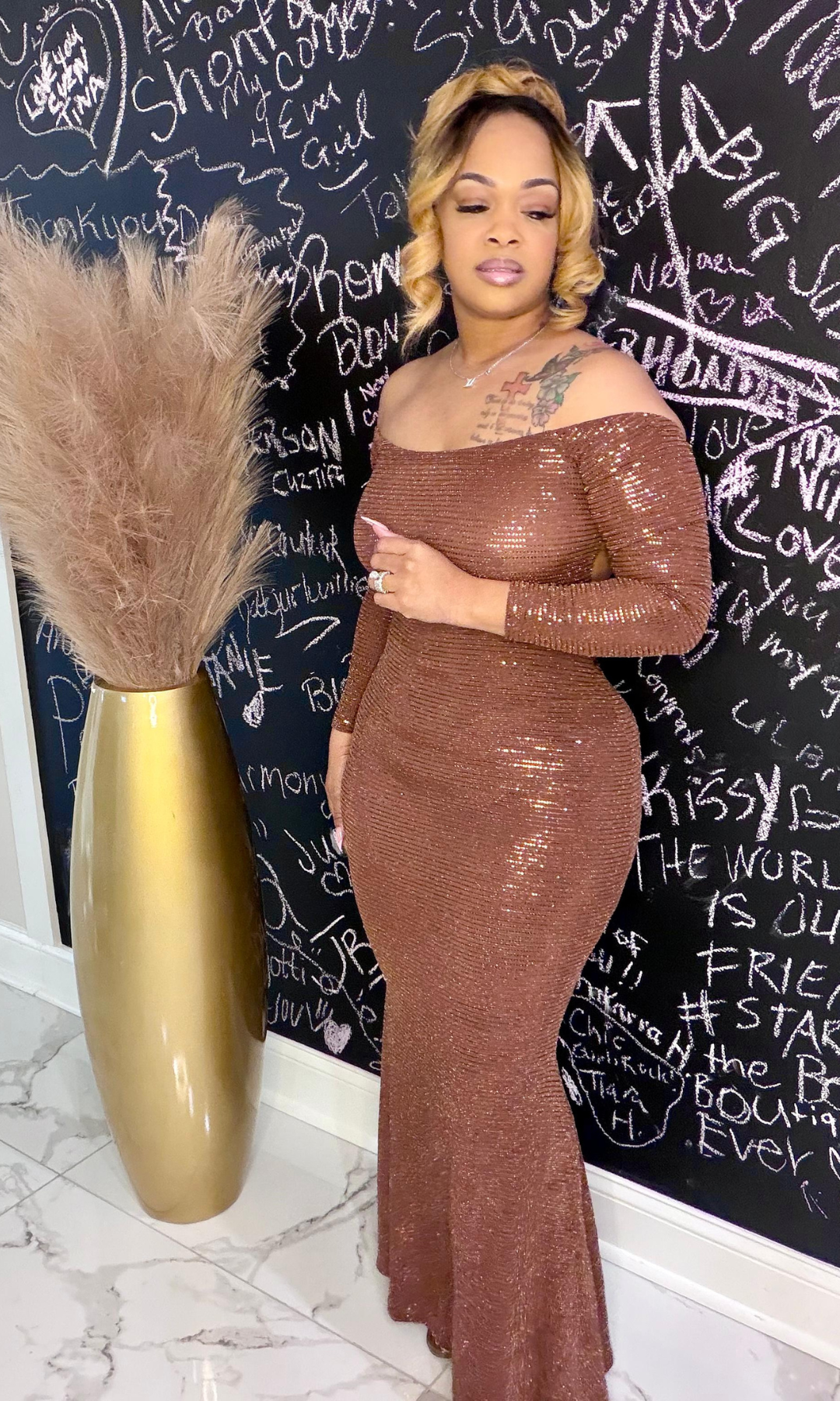 Side view of Queen Susie metallic bronze long sleeve gown