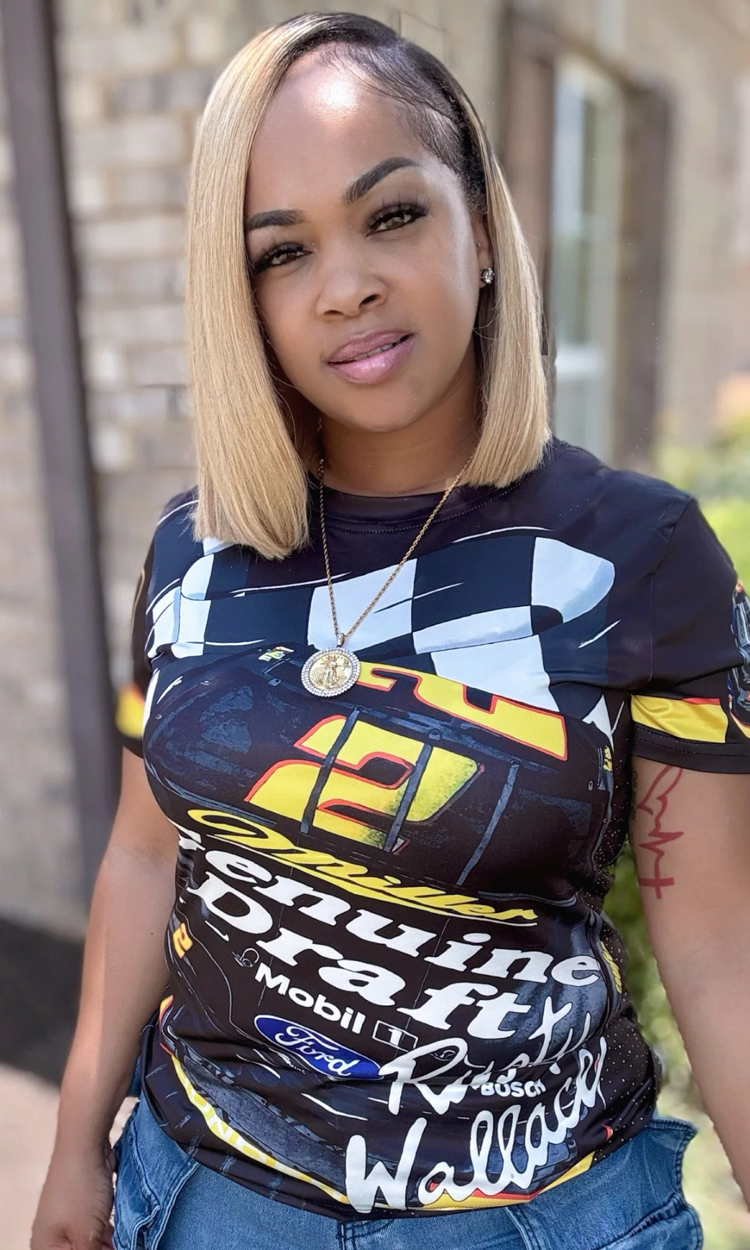 Close-up of woman wearing Race Track T-Shirt showing detailed racing design and sleek fit.