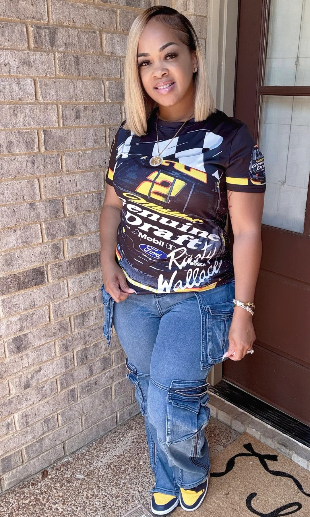Full outfit view of Race Track T-Shirt paired with cargo jeans and sneakers.
