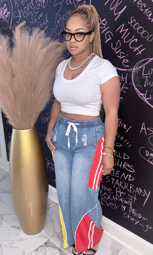Woman wearing Red & Yellow Jeannie wide-leg jeans with white crop top, front view.