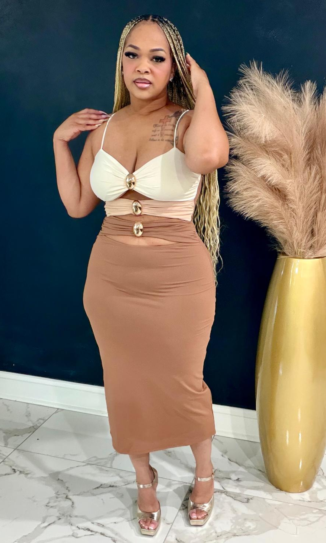 Shades Dress featuring an elegant neutral colorblock design, gold hardware accents, and a curve-hugging midi silhouette perfect for any special occasion.