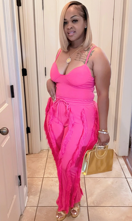 Front view of woman wearing Shimmy Pink 2-piece short set with tassel details.
