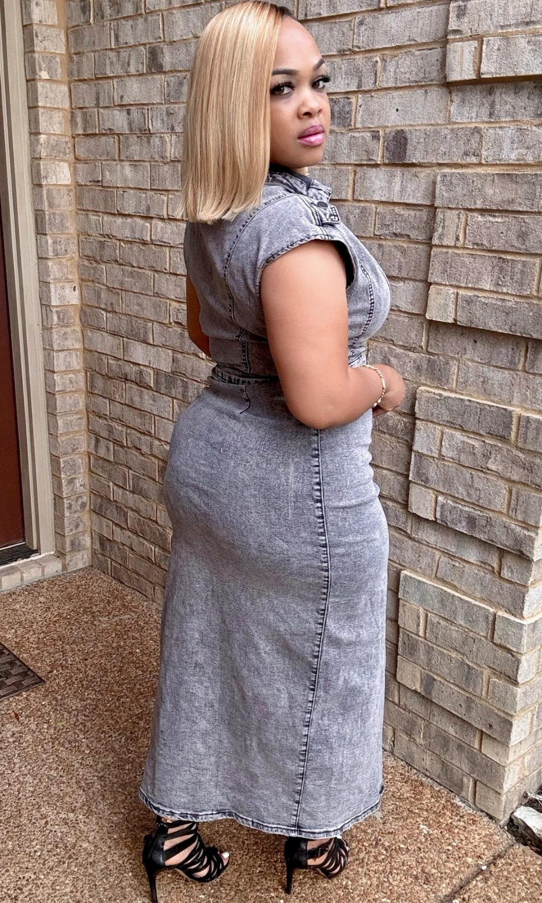 Back view of woman wearing the Slendid Split Dress, showcasing fitted silhouette and sleeveless collared top.