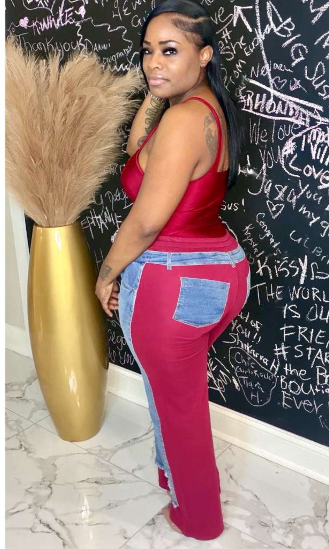 Side view of denim joggers featuring contrast fabric panels