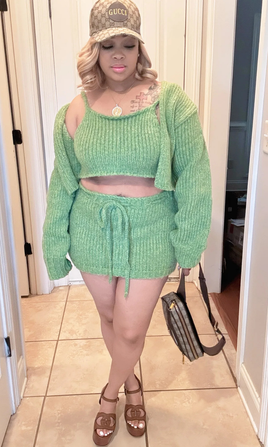 Front view of woman wearing the Style Me Green 3-piece knit set with cropped tank, cardigan, and drawstring mini skirt.