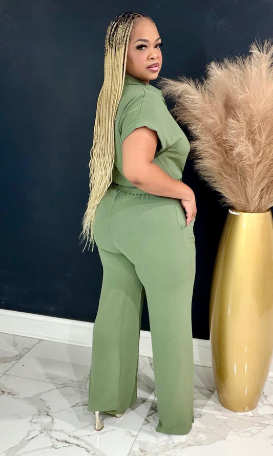Woman wearing The First Lady Olive two-piece set featuring a button-front collared blouse and high-waisted wide-leg pants.