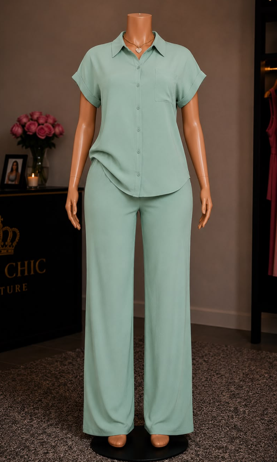 Women's sage green two-piece matching set featuring a relaxed button-up collared blouse with short cuffed sleeves and wide-leg elastic waist pants.