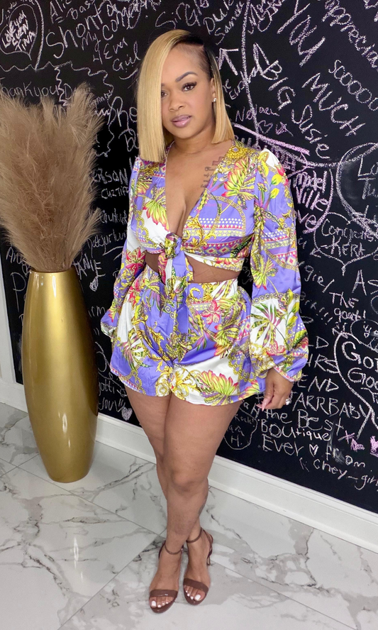 Woman wearing a multi-color tie-front crop top and matching shorts from the Tied Up Set