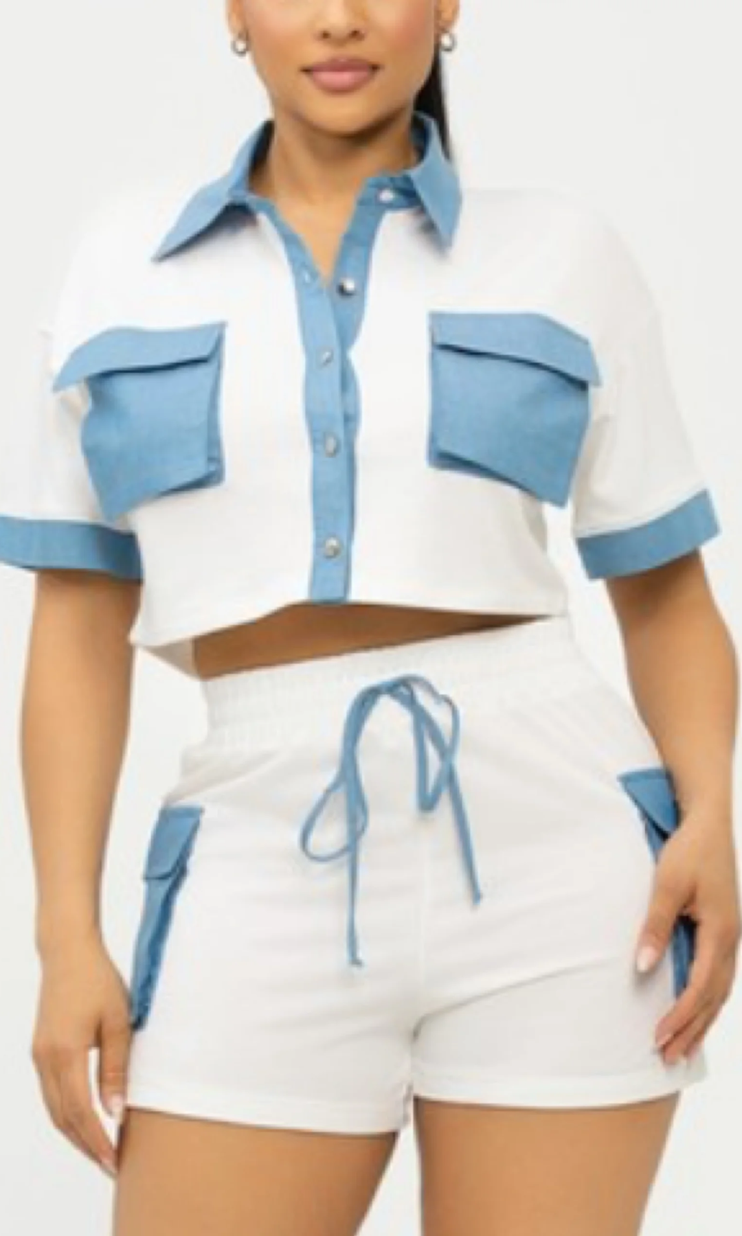 White and blue outfit with a cropped top and shorts on a white background