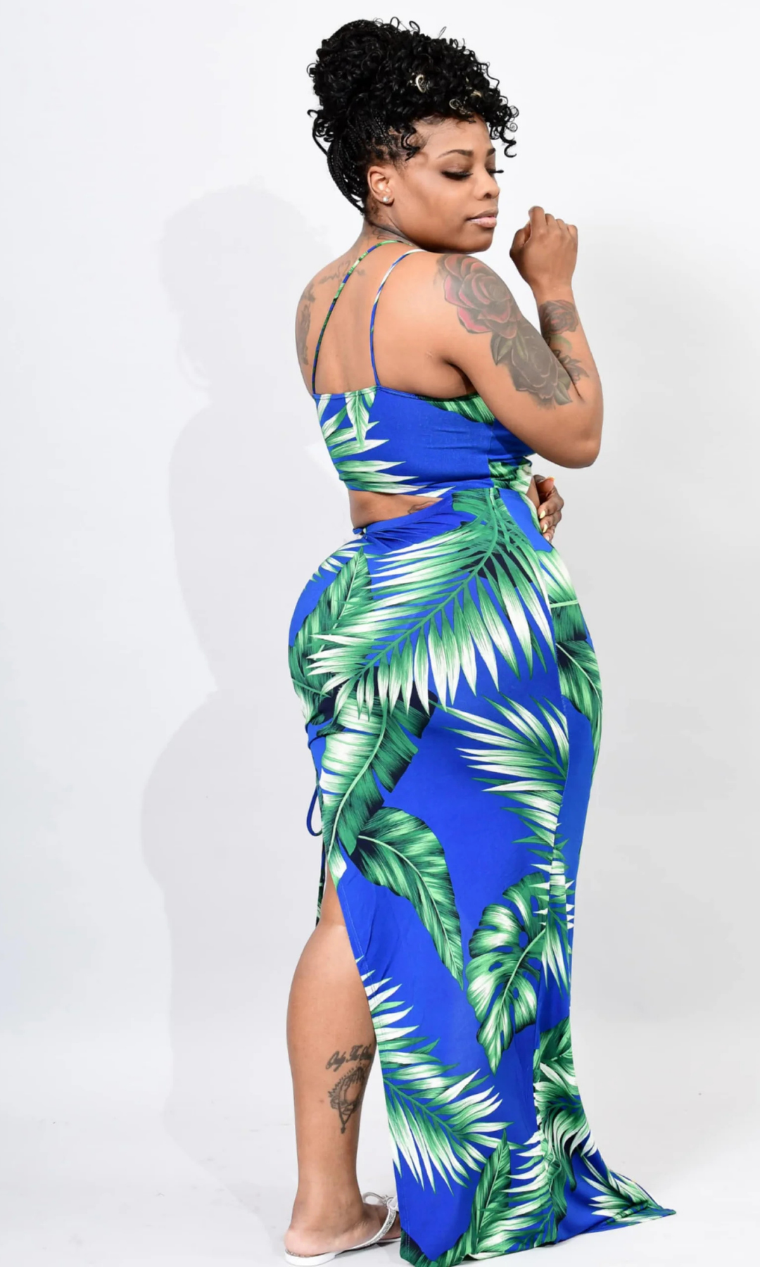 Vacation Nights Maxi Dress Back View – Back view of tropical-print maxi dress featuring palm leaf patterns and a stylish cut-out design.

