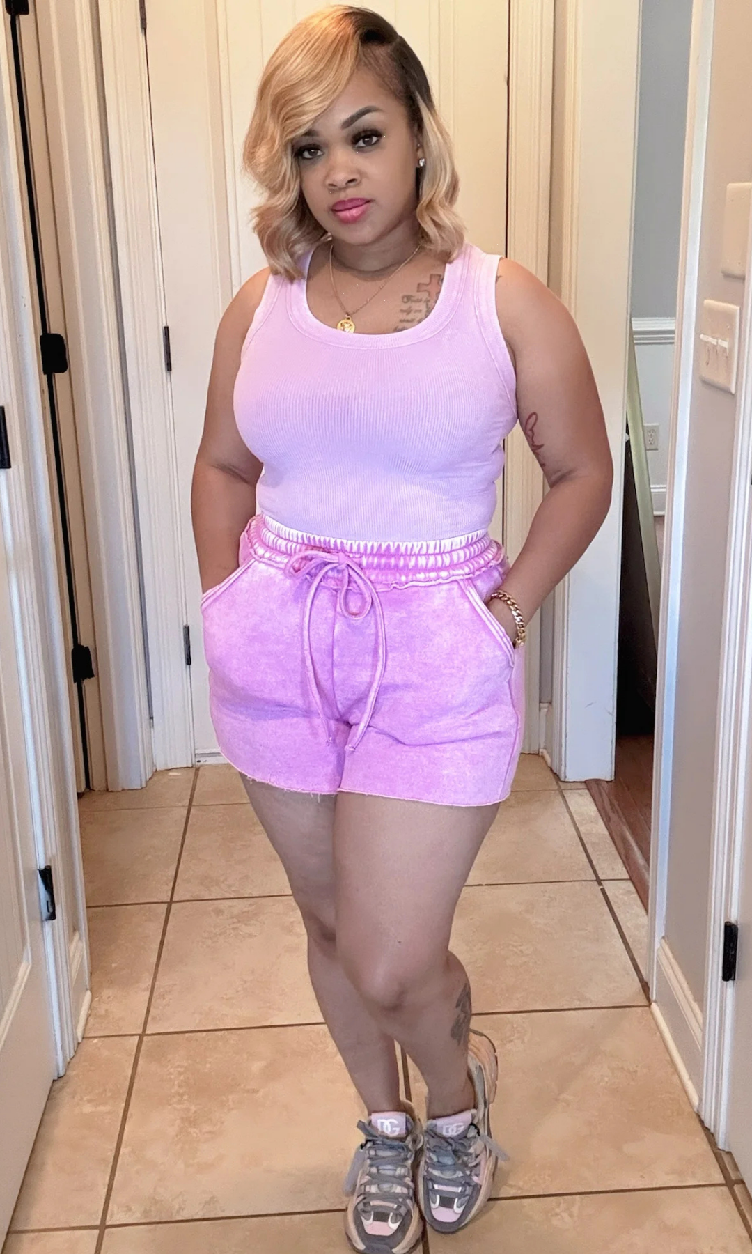 Vibe Set Lilac Side View – Woman posing in lilac ribbed top and matching shorts, showing the relaxed fit and high-waist drawstring detail.

