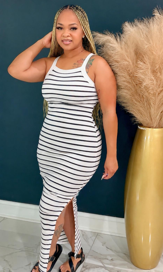 Model wearing the White Basic Striped Maxi Dress featuring black stripes, a sleeveless design, and a flattering bodycon silhouette.